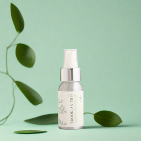 Skincare serum bottle with green leaves on a light green background change leaves
