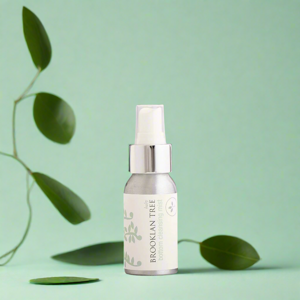 Skincare serum bottle with green leaves on a light green background change leaves
